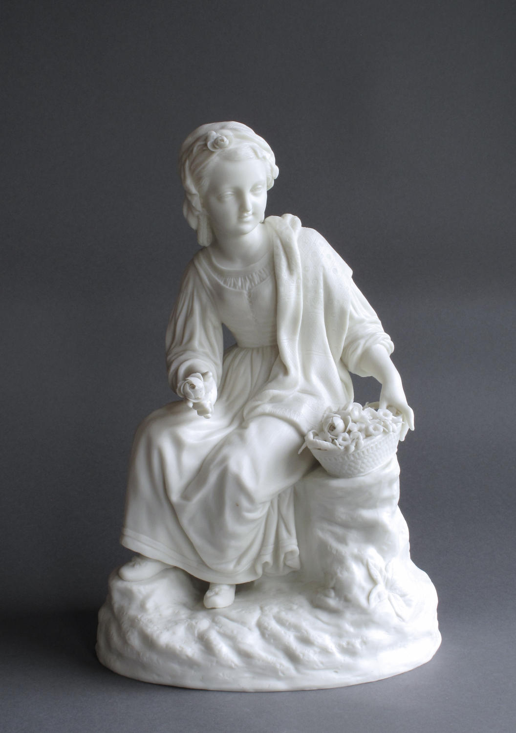 A Parian figure of a girl with flowers by R&L