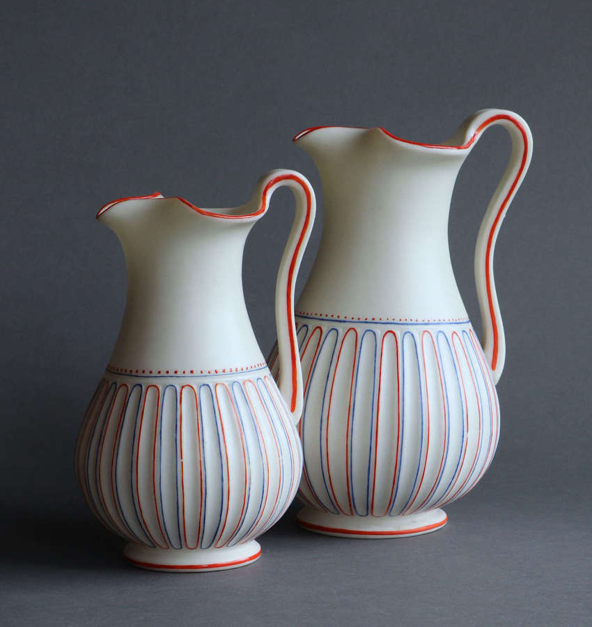 Two Worcester Parian decorated fluted lipped jugs