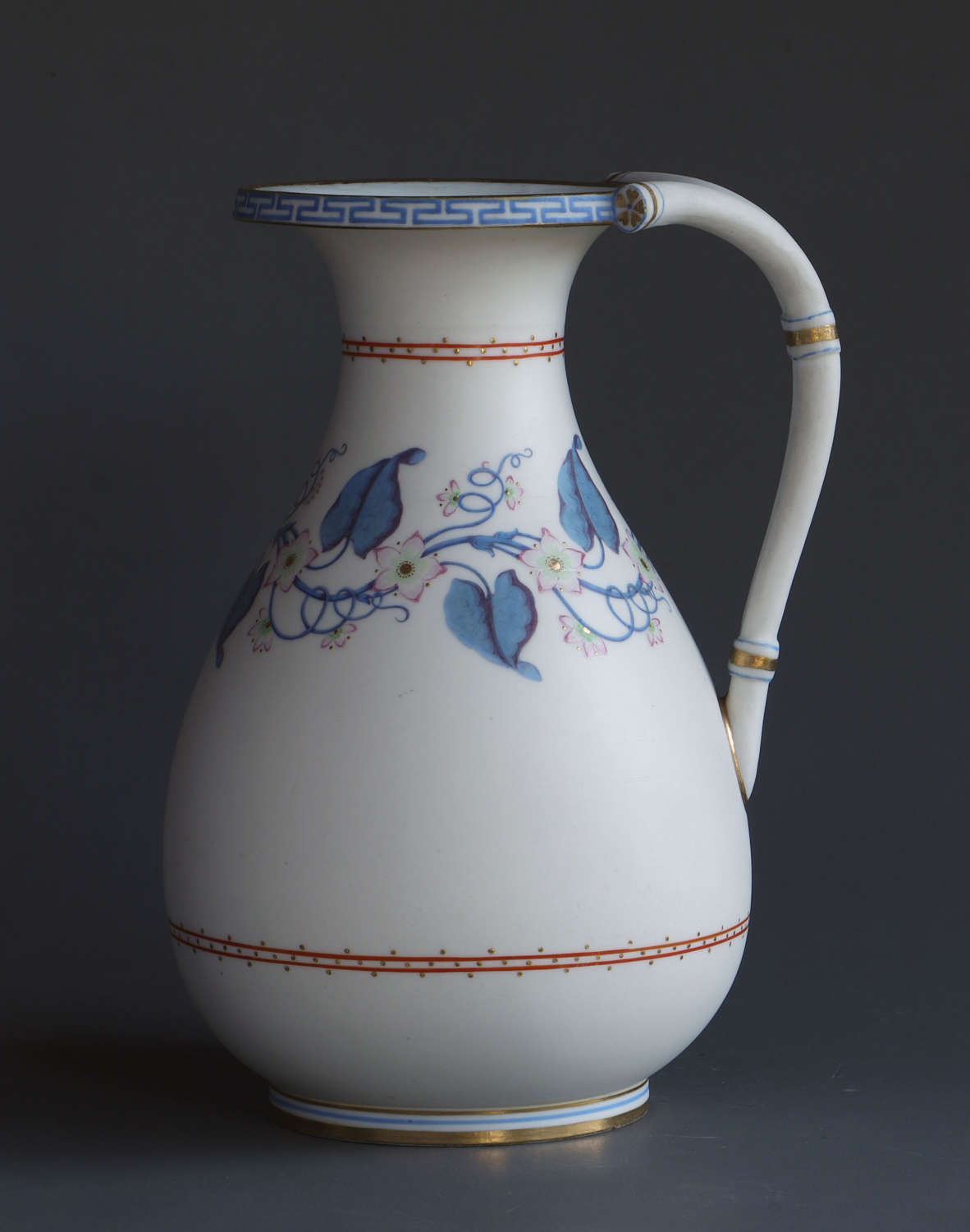 A good Parian jug or pitcher with blue and pink floral decoration