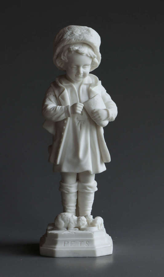 A Parian figure of a child feeding their pet cat and kittens