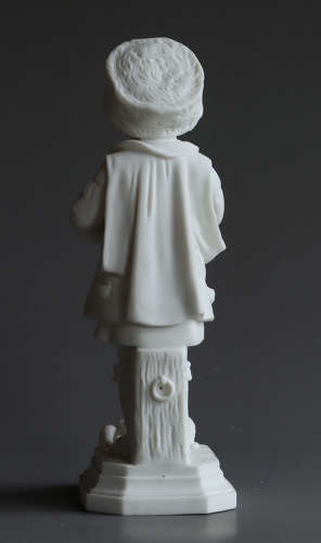 A Parian figure of a child feeding their pet cat and kittens