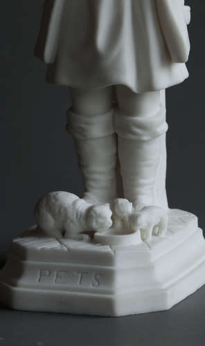 A Parian figure of a child feeding their pet cat and kittens